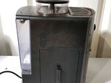 a black coffee maker sitting on a white table
