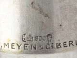 a close up of a silver cup on a table