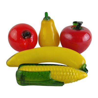 a banana, tomato, corn, and pepper on a plate