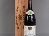 a bottle of wine sitting next to a wooden box