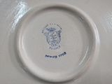 a close up of a plate with a crest on it