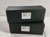 two black boxes are stacked on top of each other on a table