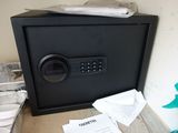 a black safe box sitting on top of a counter