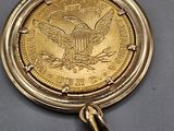 a close up of a gold coin with an eagle on it
