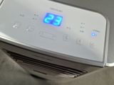 a digital clock on the side of a white air conditioner