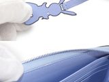 a person in white gloves holding a blue purse