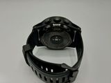 a close up of a watch on a white surface