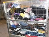 a cart full of clothes that is sitting in a warehouse