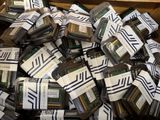pile of computer memory cards in a cardboard box on a table