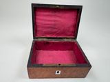 a small wooden box with a pink lining inside