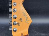 a close up of the headstock of a guitar on a black background