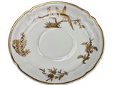 a close up of a saucer with a bird on it