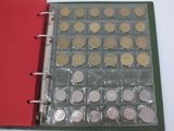 a red binder with a lot of coins inside of it