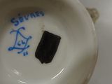 a close up of a plate with a black piece of food in it