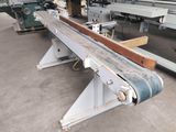 an image of a machine in a factory with a conveyor belt