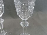 two wine glasses sitting next to each other on a table