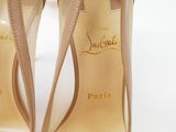 pair of nude colored high heeled shoes on a white surface