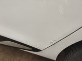 a picture of a car with a denting dent on the side of it