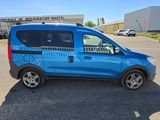 a blue van that is parked in a parking lot