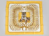 a close up of a yellow and white scarf with a tiger on it