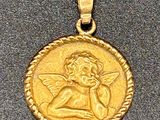 a close up of a gold coin with an angel on it