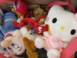 a hello kitty stuffed animal in a bag with other stuffed animals