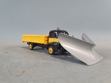 a toy truck with a snow plow on the back of it