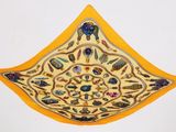 a yellow piece of cloth with a design on it