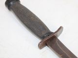 a close up of a knife on a white surface
