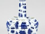 a blue and white vase with a flower design on it