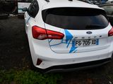 a white car with a blue design on it parked in a parking lot
