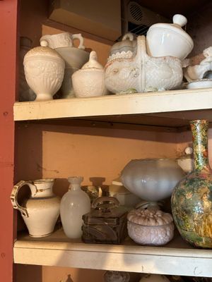 de nombreux vases différents sur les étagères de cette pièce