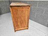 a small wooden cabinet with a door on top of it
