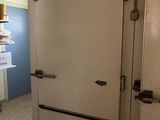 a white refrigerator in the middle of a kitchen with blue walls