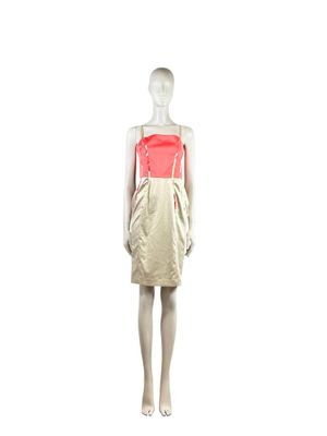 mannequin dressed in a beige and red dress with a red sash