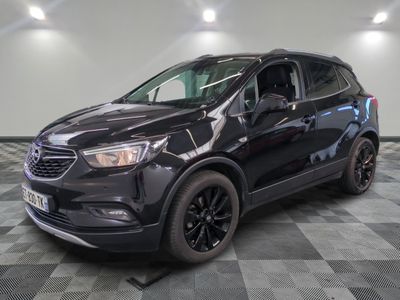 a black buick suv parked on a checkered floor in a garage