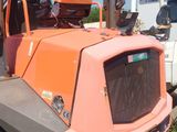 an orange truck that is parked on the side of the road