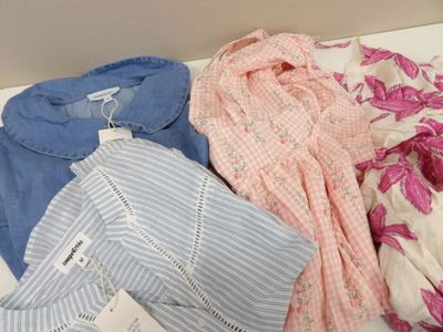 a pile of clothes on a table with a tag