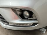 a close up of a car ' s front bumper and headlight