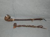 a pipe and a cane sitting on a table
