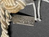 a close up of a rope with a tag attached to it