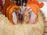 two purses that are sitting on top of a table