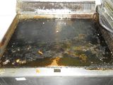 a dirty stove in a kitchen with a dirty stove top