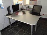 a computer desk with two monitors and a laptop on it