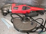 an image of a red electric tool on a tile floor