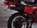 a red motorcycle that is parked in a garage