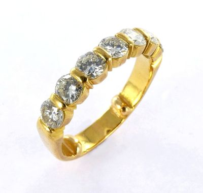 a close up of a gold and diamond ring on a white background