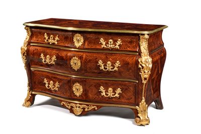 a chest of drawers that has a gold decoration on it