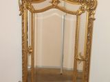 a mirror that is sitting on the floor next to a wall