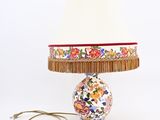 a lamp that is sitting on a table with a lamp shade on it
